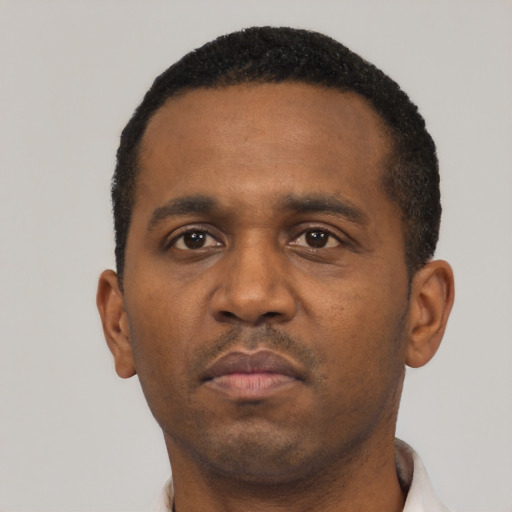 Neutral black adult male with short  black hair and brown eyes