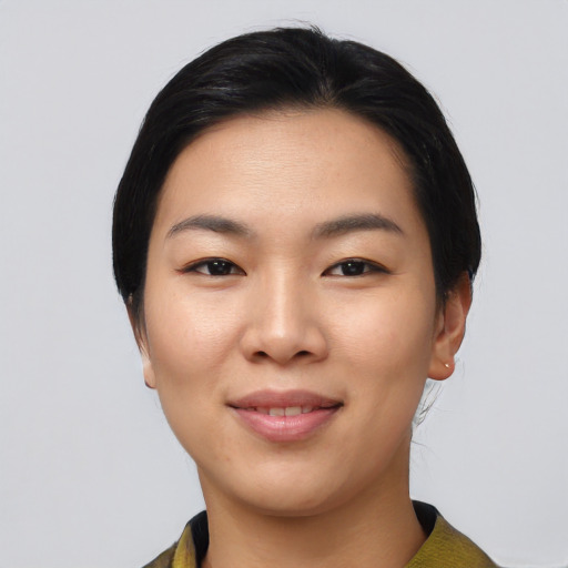 Joyful asian young-adult female with medium  black hair and brown eyes