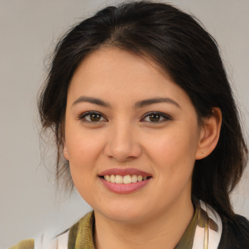 Joyful latino young-adult female with medium  brown hair and brown eyes
