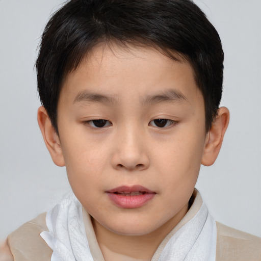 Joyful asian child male with short  brown hair and brown eyes