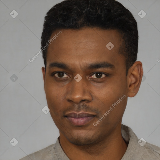 Joyful black young-adult male with short  black hair and brown eyes