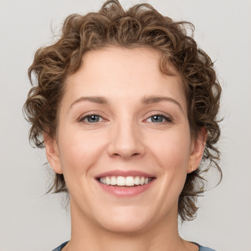 Joyful white young-adult female with medium  brown hair and green eyes