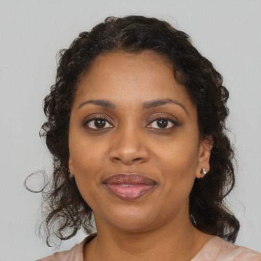 Joyful black young-adult female with medium  brown hair and brown eyes