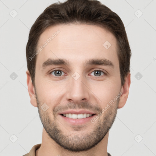 Joyful white young-adult male with short  brown hair and grey eyes