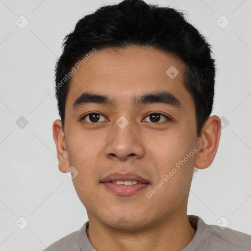 Joyful asian young-adult male with short  black hair and brown eyes