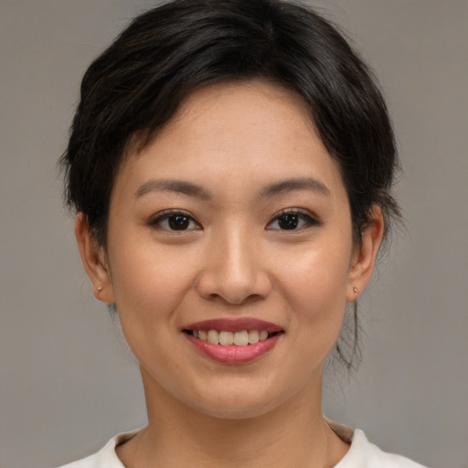 Joyful asian young-adult female with medium  brown hair and brown eyes