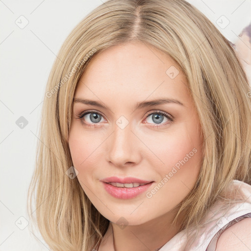 Joyful white young-adult female with long  brown hair and blue eyes