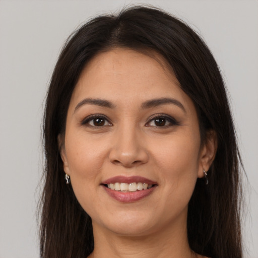 Joyful white young-adult female with long  brown hair and brown eyes