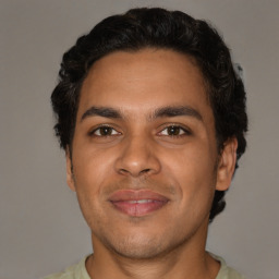 Joyful latino young-adult male with short  brown hair and brown eyes