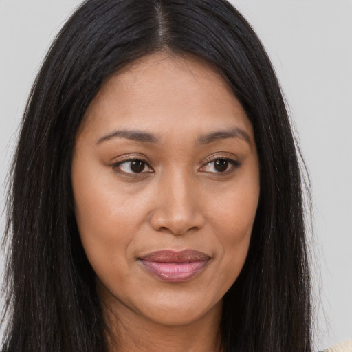 Joyful asian young-adult female with long  brown hair and brown eyes