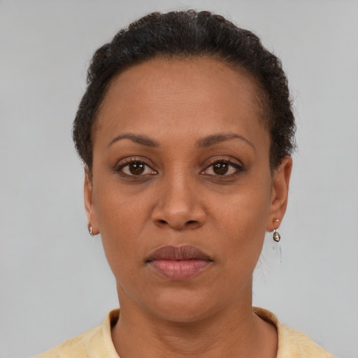Neutral latino adult female with short  brown hair and brown eyes