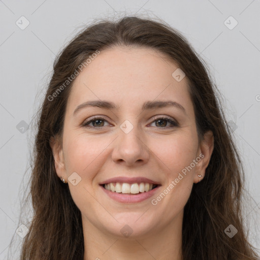 Joyful white young-adult female with long  brown hair and grey eyes