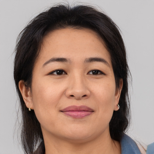Joyful asian adult female with medium  brown hair and brown eyes
