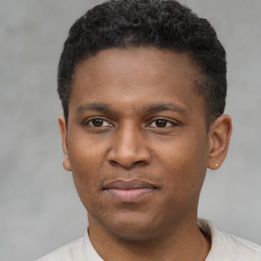 Joyful latino young-adult male with short  brown hair and brown eyes