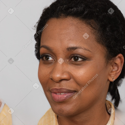 Joyful black adult female with short  black hair and brown eyes