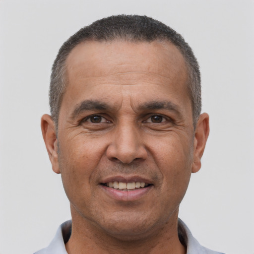 Joyful white adult male with short  black hair and brown eyes