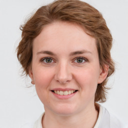 Joyful white young-adult female with medium  brown hair and blue eyes