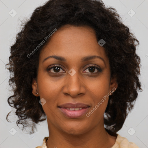 Joyful black adult female with medium  brown hair and brown eyes