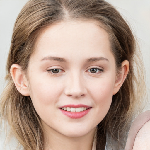 Joyful white young-adult female with long  brown hair and blue eyes