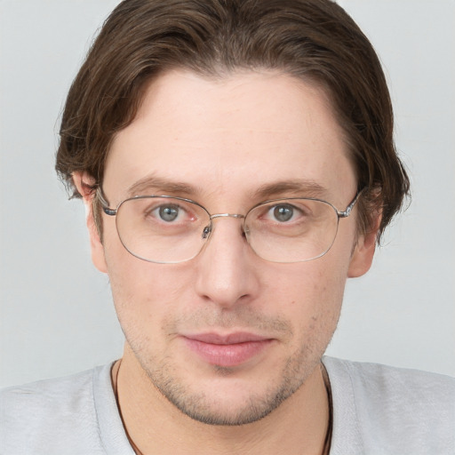 Joyful white adult male with short  brown hair and blue eyes