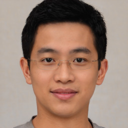 Joyful asian young-adult male with short  black hair and brown eyes