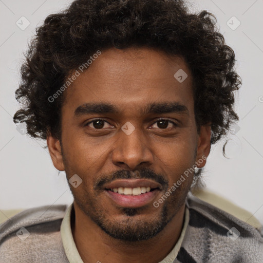 Joyful black young-adult male with short  brown hair and brown eyes