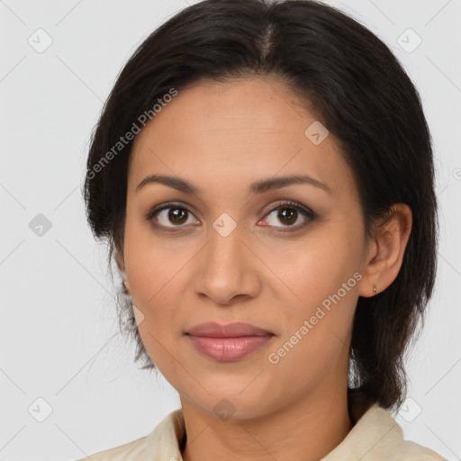 Joyful latino adult female with medium  brown hair and brown eyes