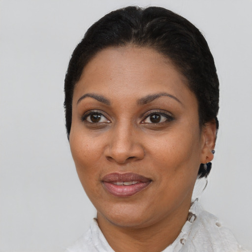Joyful latino adult female with short  brown hair and brown eyes