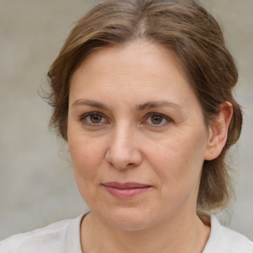 Joyful white adult female with medium  brown hair and brown eyes