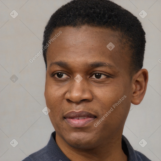 Joyful black young-adult male with short  black hair and brown eyes