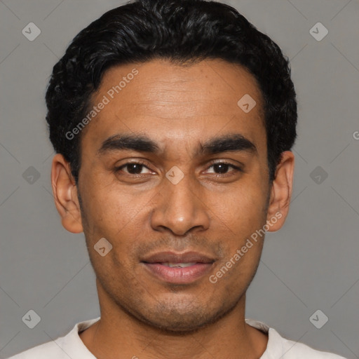 Joyful latino young-adult male with short  black hair and brown eyes