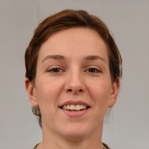 Joyful white young-adult female with short  brown hair and grey eyes