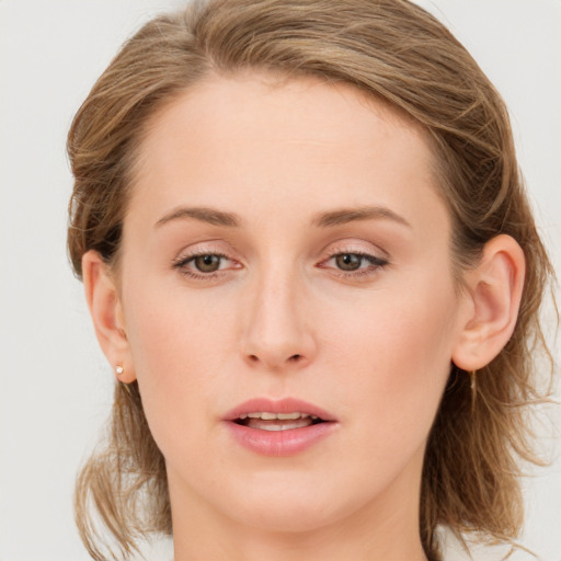 Joyful white young-adult female with medium  brown hair and blue eyes