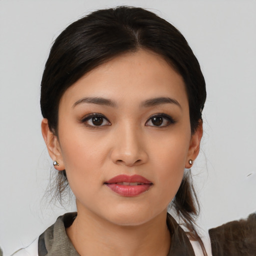 Joyful asian young-adult female with medium  brown hair and brown eyes