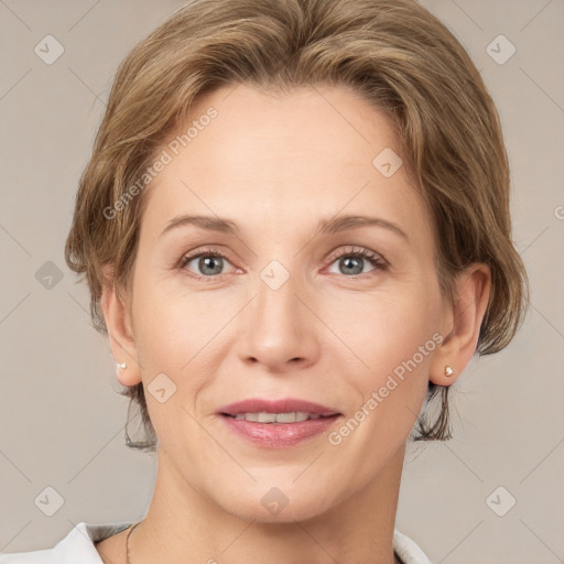 Joyful white adult female with medium  brown hair and grey eyes