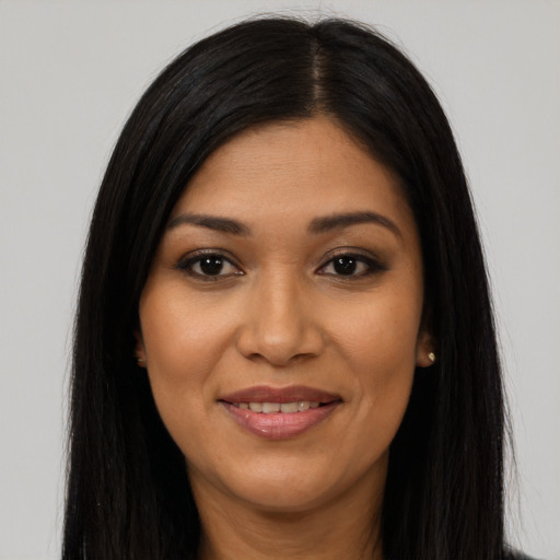 Joyful latino young-adult female with long  black hair and brown eyes