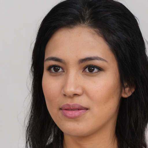 Joyful asian young-adult female with long  brown hair and brown eyes