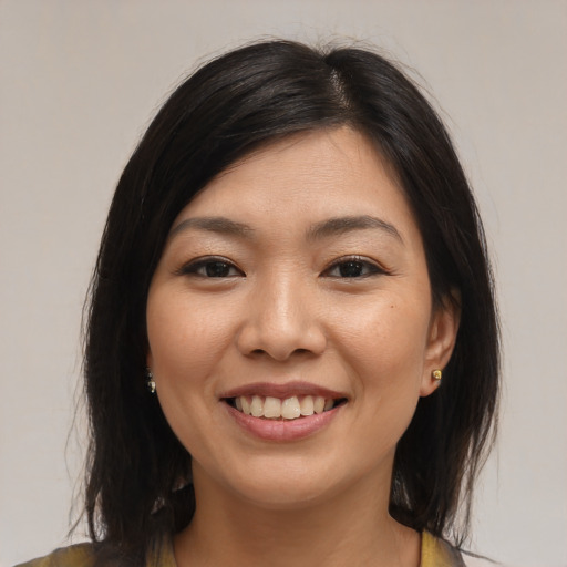 Joyful asian young-adult female with medium  brown hair and brown eyes