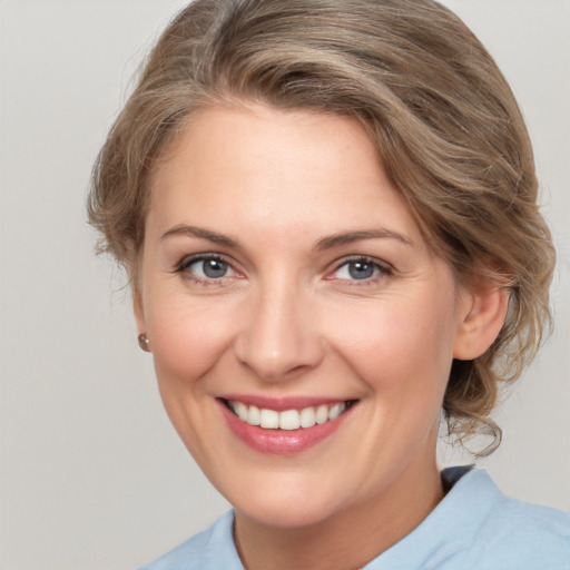 Joyful white adult female with medium  brown hair and grey eyes