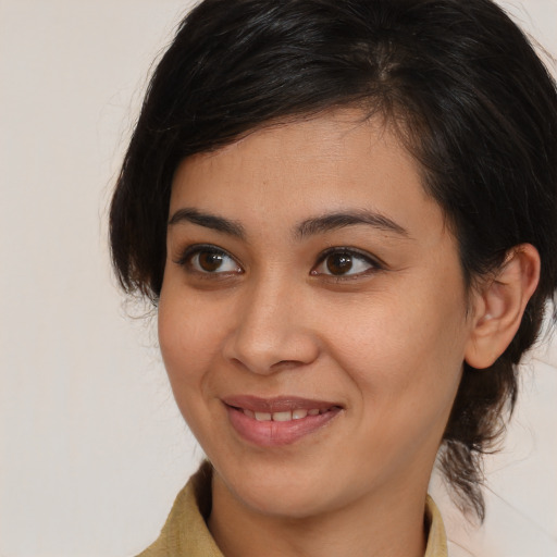 Joyful latino young-adult female with medium  brown hair and brown eyes