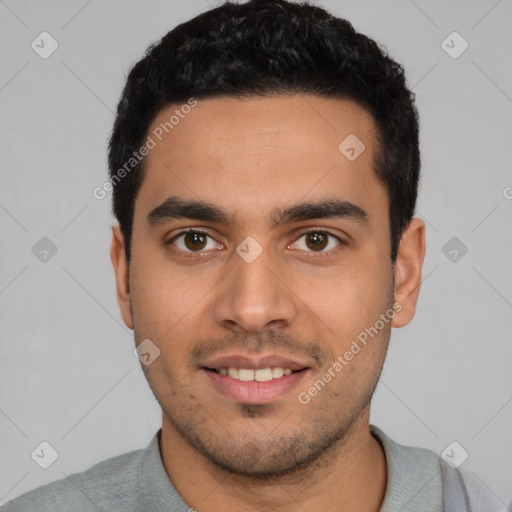 Joyful latino young-adult male with short  black hair and brown eyes