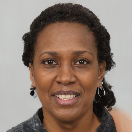 Joyful black adult female with short  brown hair and brown eyes