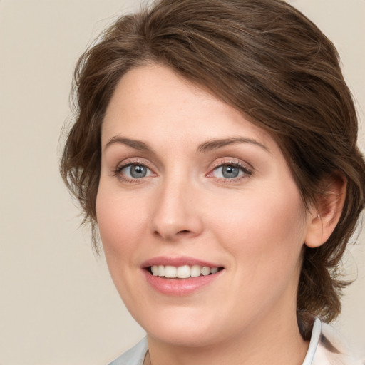 Joyful white young-adult female with medium  brown hair and green eyes