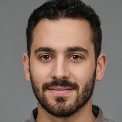Joyful white young-adult male with short  brown hair and brown eyes