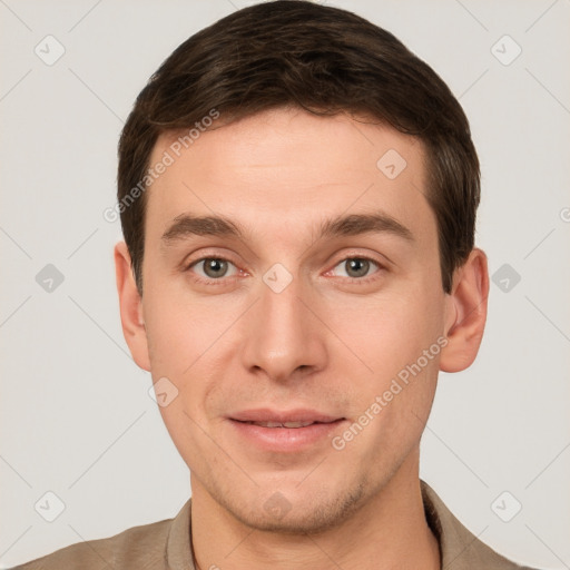 Joyful white young-adult male with short  brown hair and grey eyes