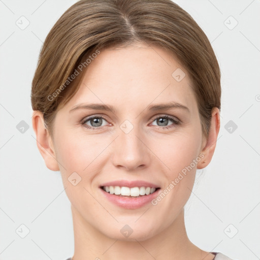 Joyful white young-adult female with short  brown hair and grey eyes