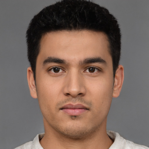 Neutral latino young-adult male with short  black hair and brown eyes