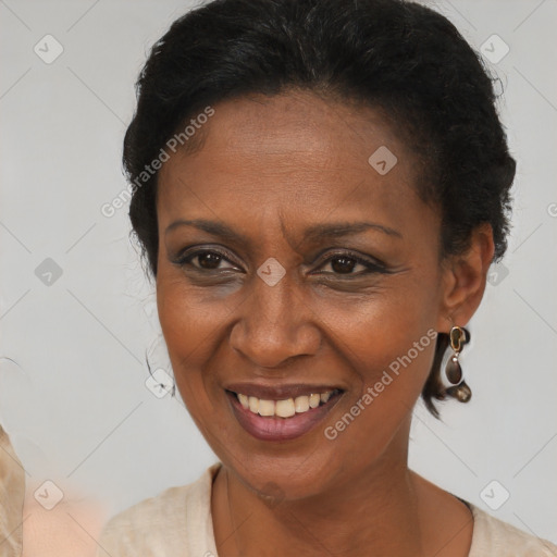 Joyful black adult female with medium  brown hair and brown eyes