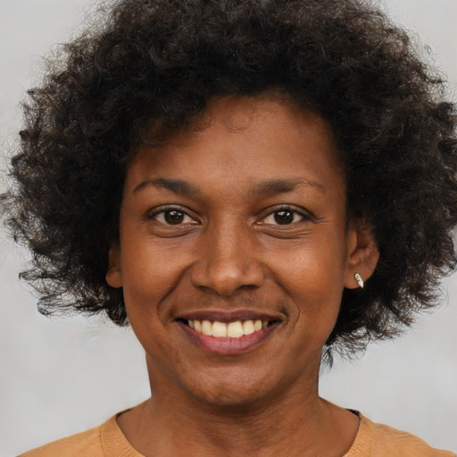 Joyful black young-adult female with short  brown hair and brown eyes