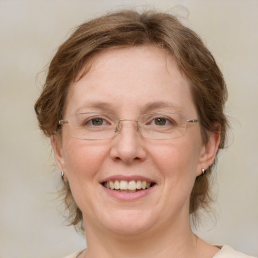 Joyful white adult female with medium  brown hair and green eyes